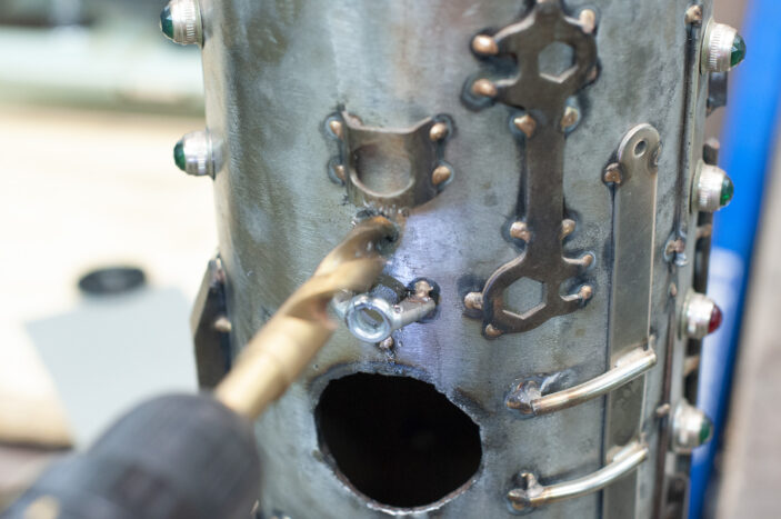 half-inch drill bit working through the hull