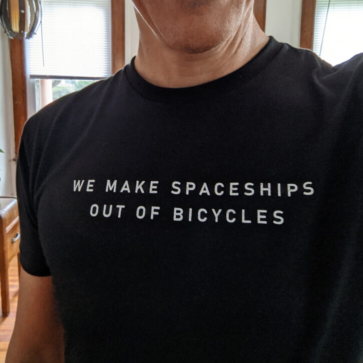 'We Make Spaceships Out of Bicycles' on black tee