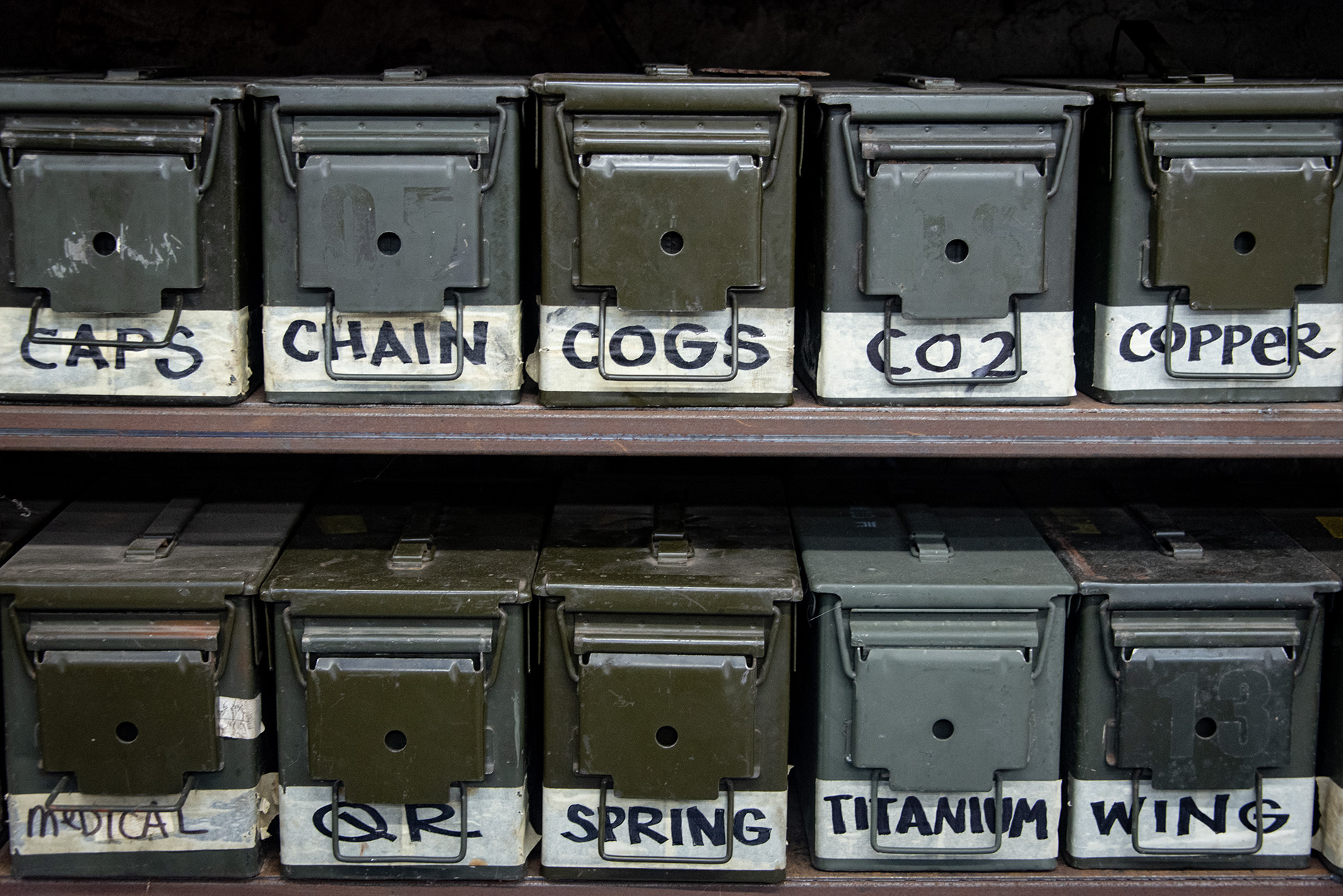 a collection of neatly arranged metal boxes, one of which is labelled 'spring'